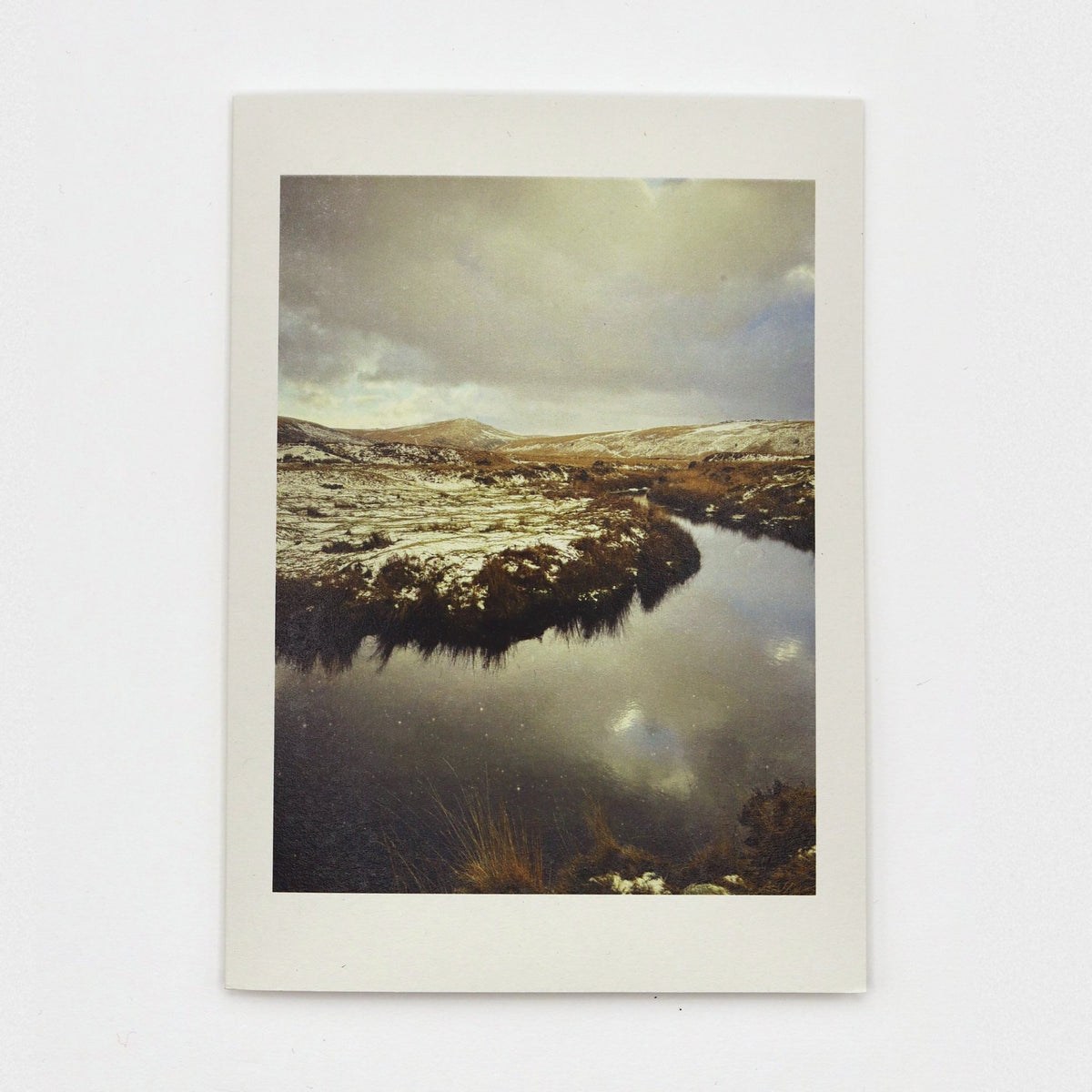 Snow at Taw Marsh Christmas card showing snowy Dartmoor hills and clouds reflected in a still, dark pool