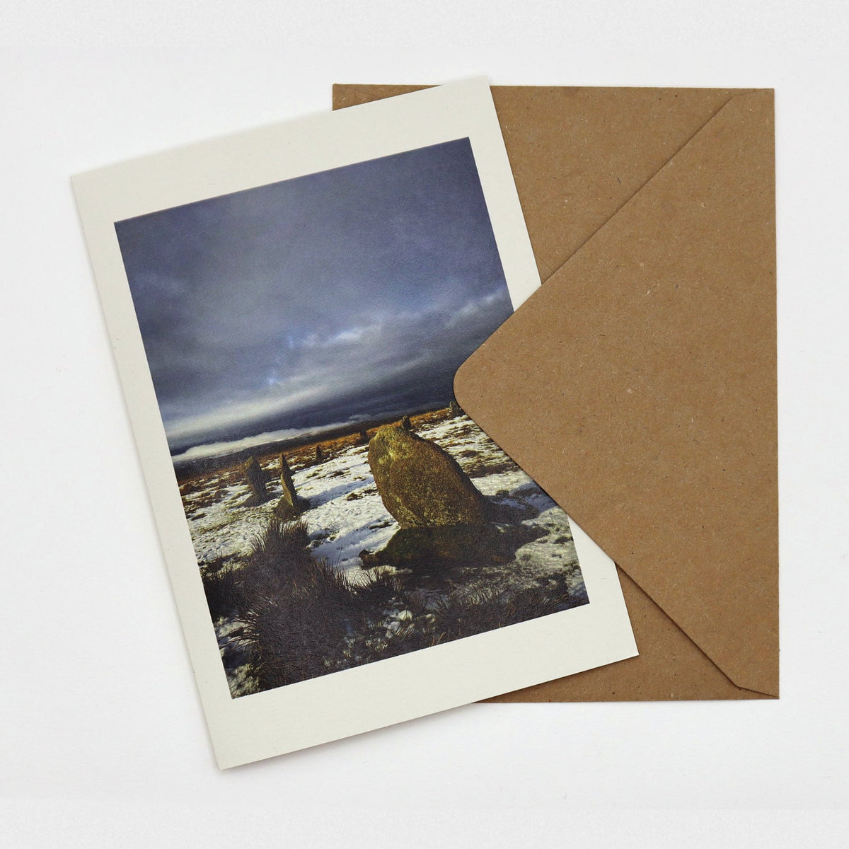 Snow at the Stone Circle Christmas card showing the ancient Whitmoor stones in snow on Dartmoor under a dark stormy sky